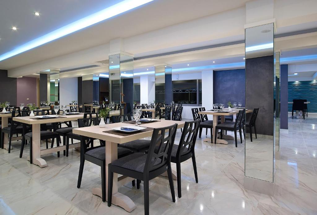 Mistral Bay Hotel moderna restorāna iekārtojums ar elegantiem galdiem.