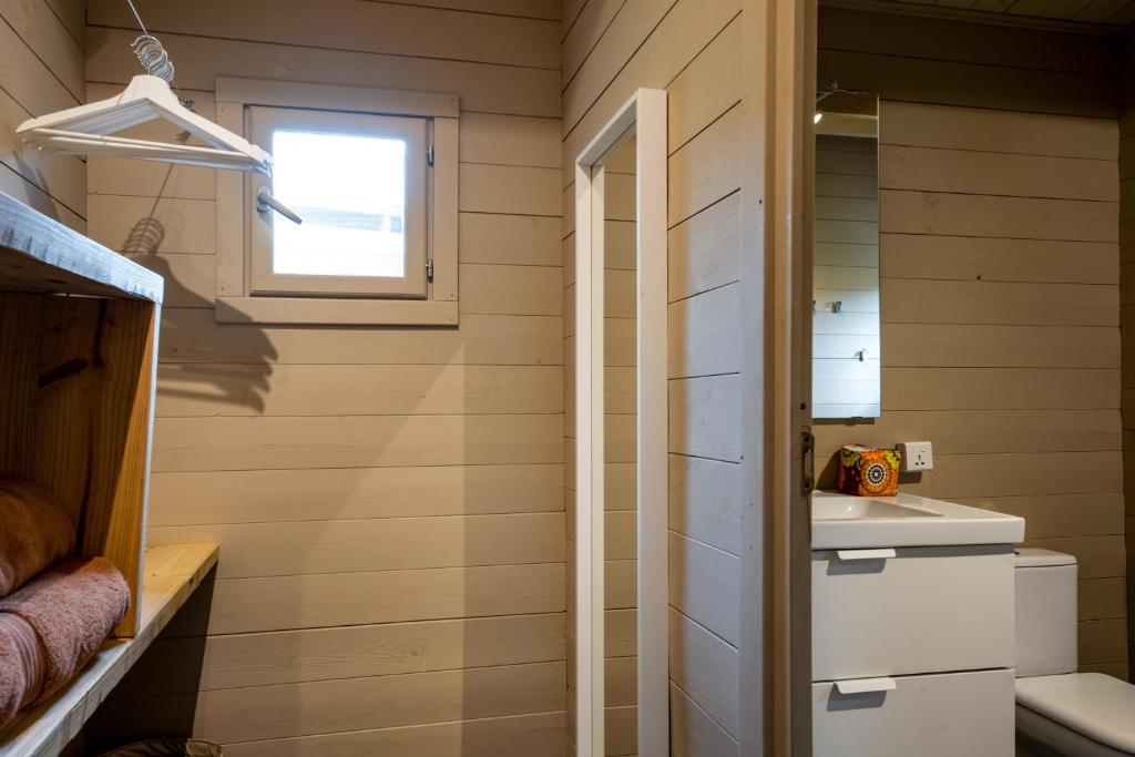 Mwezi Boutique Resort minimālistiska vannas istaba ar koka apdari.