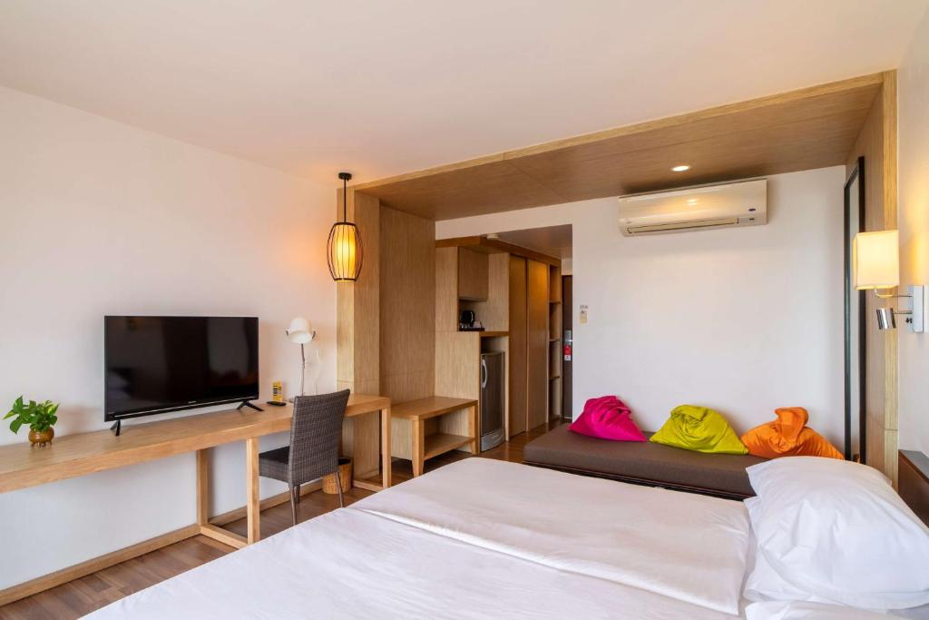 Mūsdienīgs viesnīcas numurs ar ērtu gultu, televizoru, rakstāmgaldu un krāsainām spilveniem uz dīvāna. Telpa ir gaiša un pārdomāti iekārtota, ar koka elementiem un gaisa kondicionieri.