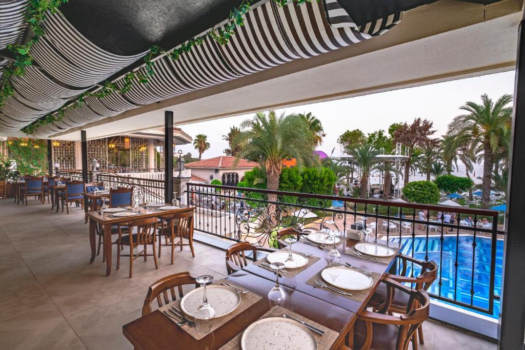 Terase ar skatu uz baseinu Utopia Resort & Residence, apkalpošanas galdi