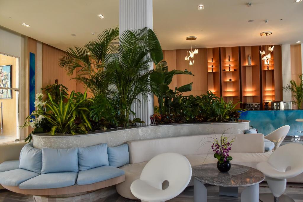 Cleopatra Luxury Resort Sharm - Adults Only modern lobby with lush plants.