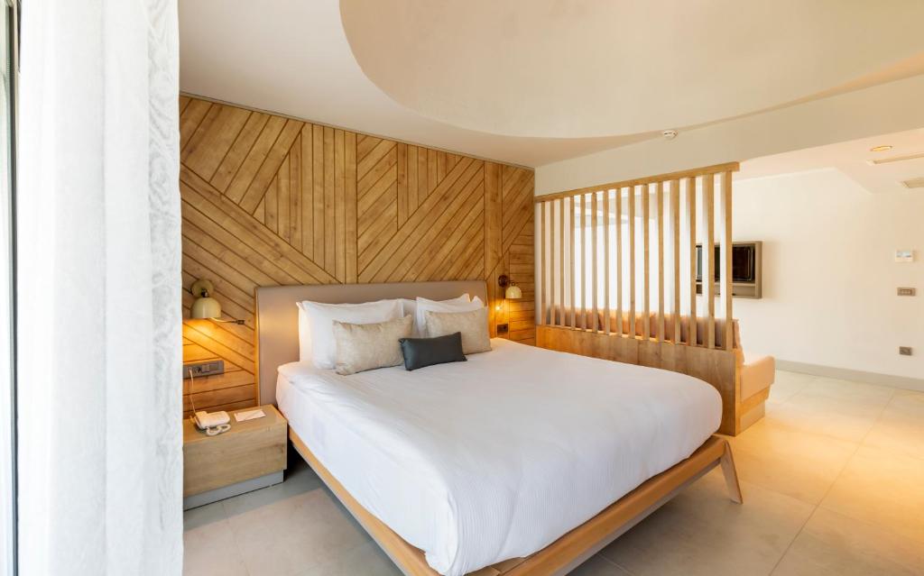 Mūsdienīgs numurs viesnīcā Paloma Orenda ar koka akcentiem un ērtu gultu.