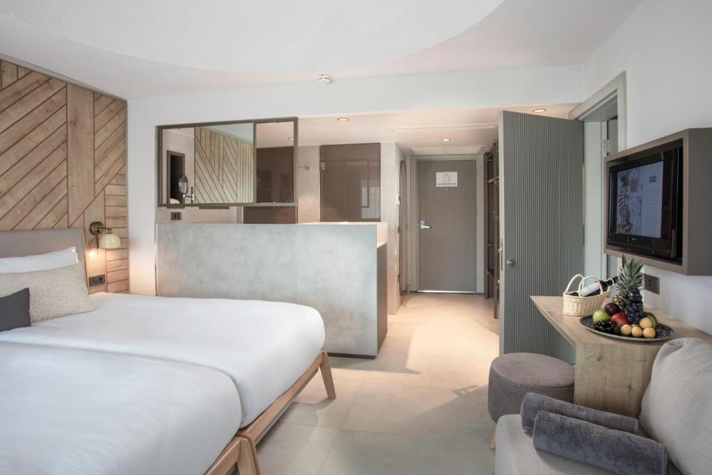 Mūsdienīgs numurs viesnīcā Paloma Orenda ar komfortablu gultu un modernu dizainu.