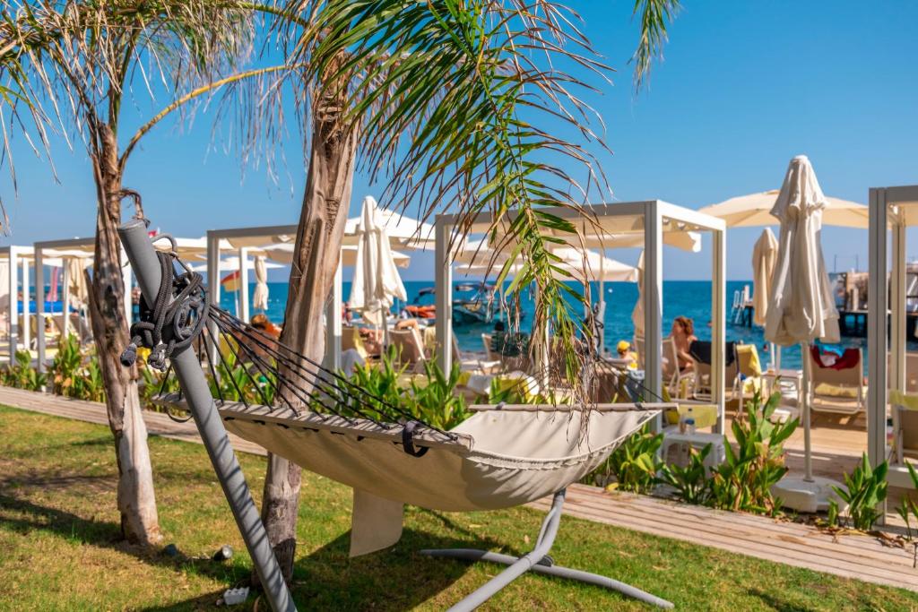 Hammocks by the beach at DoubleTree by Hilton Antalya-Kemer for relaxation.