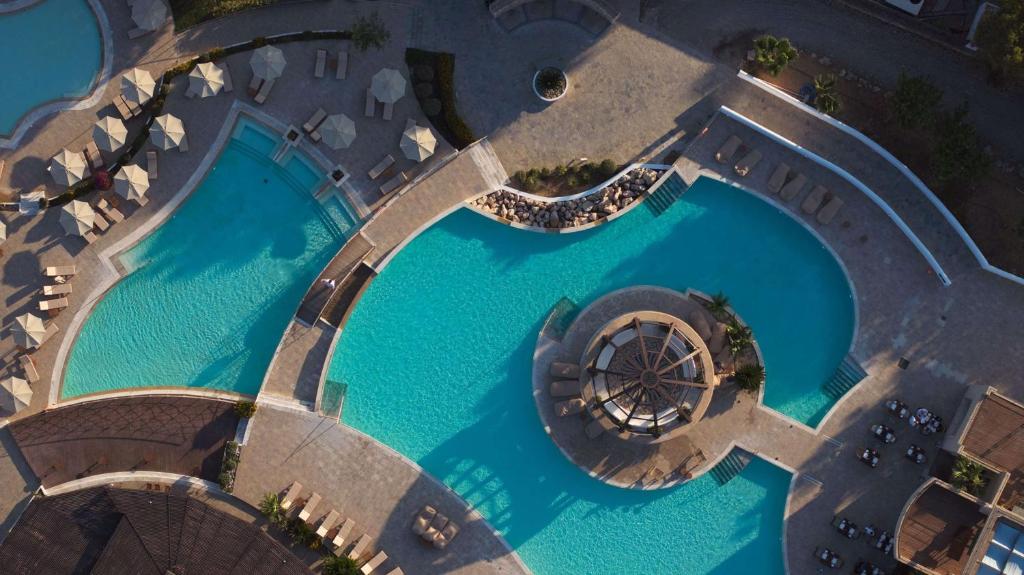 Aerial view of swimming pools at Lindian Village Beach Resort Rhodes, Curio Collection by Hilton