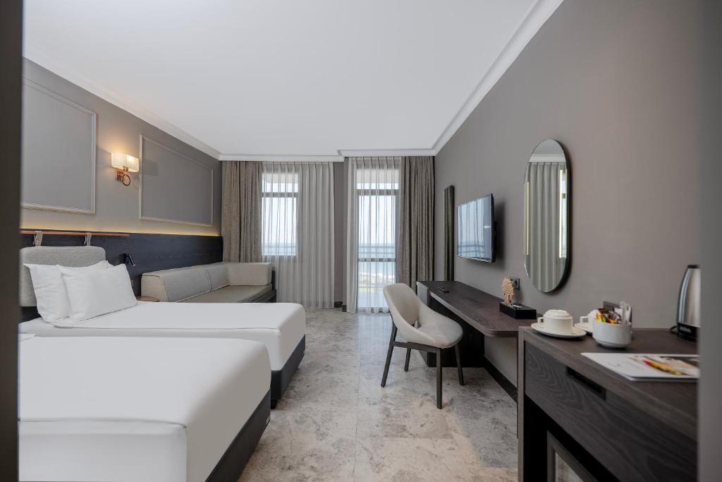 Moderna numura iekārtojums ar divām gultām viesnīcā Adora Hotel & Resort.