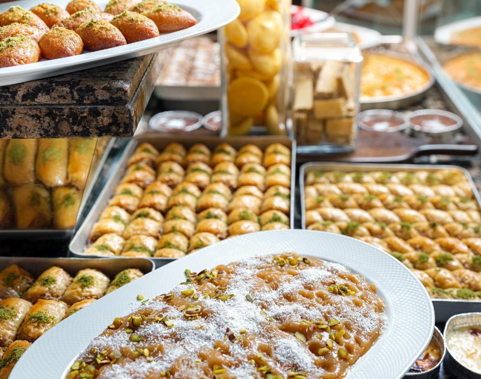 Delicious desserts at Aydinbey Famous Resort, featuring baklava and sweet treats.