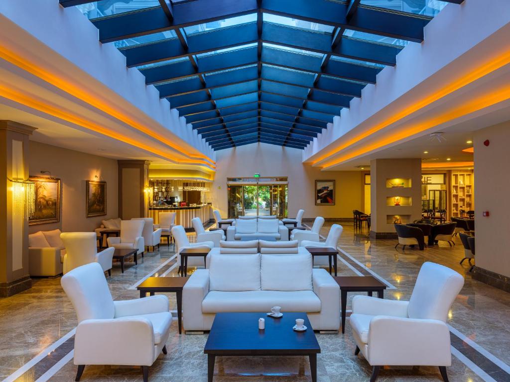 Aydinbey Famous Resort elegant lobby with modern seating and natural light.