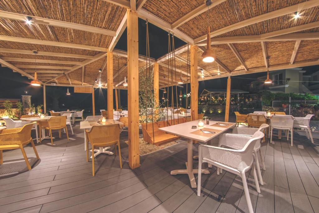 Mūsdienīgs restorāns ar elegantiem galdiem un krēsliem, kas apgaismots ar siltu apgaismojumu, radot patīkamu atmosfēru vakara ēdienreizēm. Koksnes un dabisko materiālu elementi piešķir vietai šarmu.