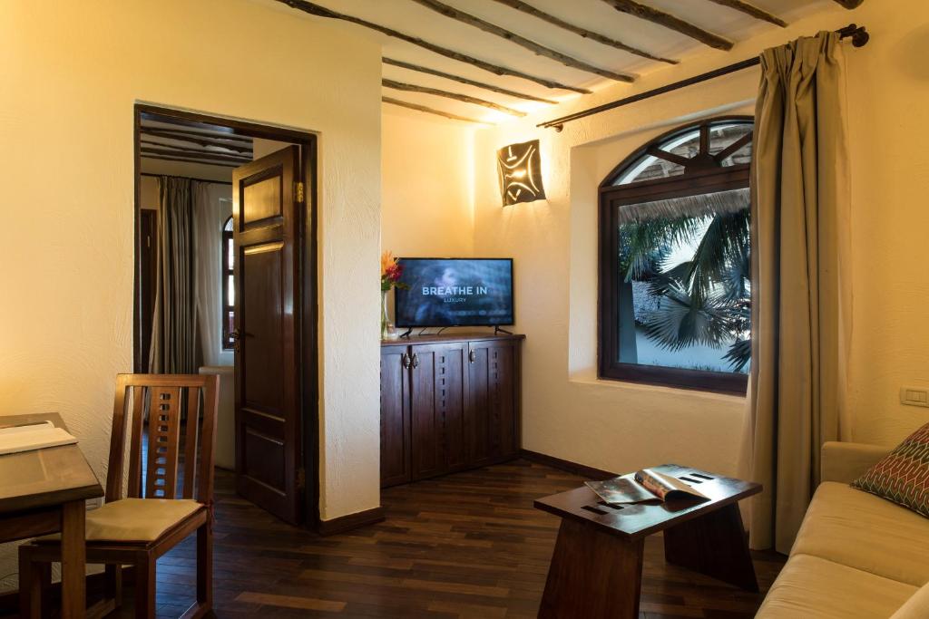 Essque Zalu Zanzibar viesnīcas numurs ar skatu uz palmu.