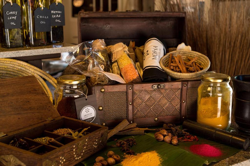 Essque Zalu Zanzibar spice display with oils and herbs.