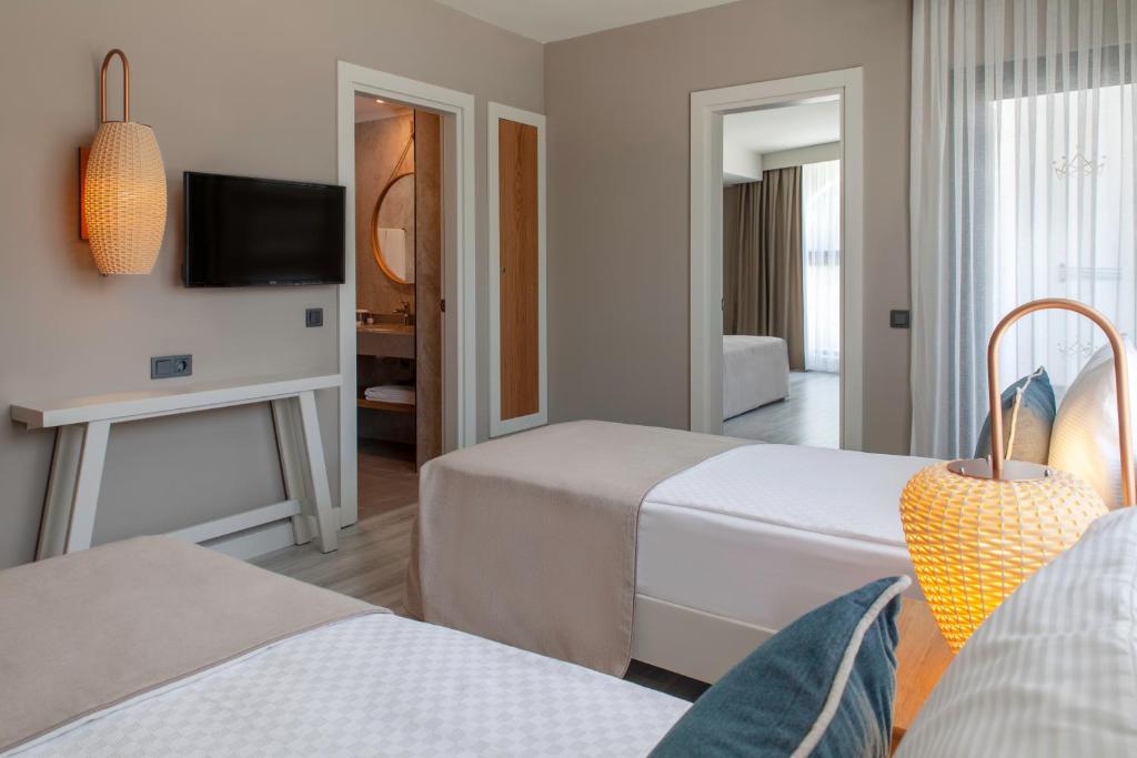 Numurs ar divām gultām un televizoru, Side Royal Style