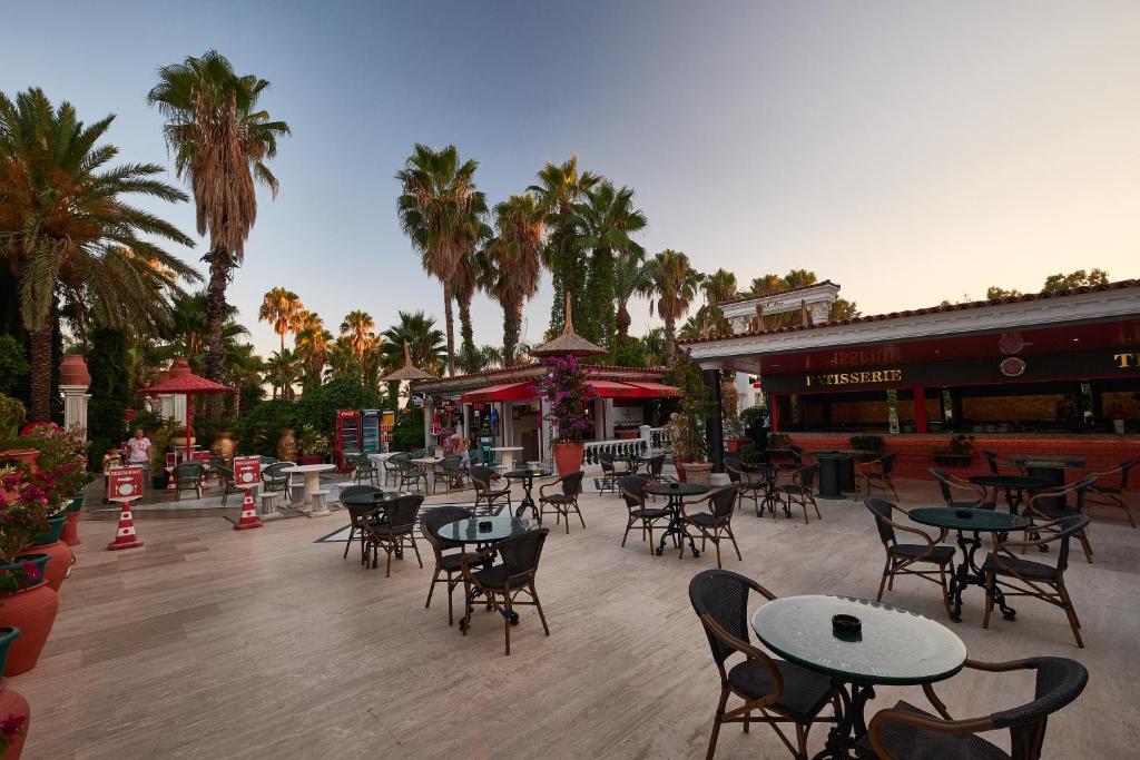 Taisnās līnijas un palmas pie Club Hotel Sera āra kafejnīcas