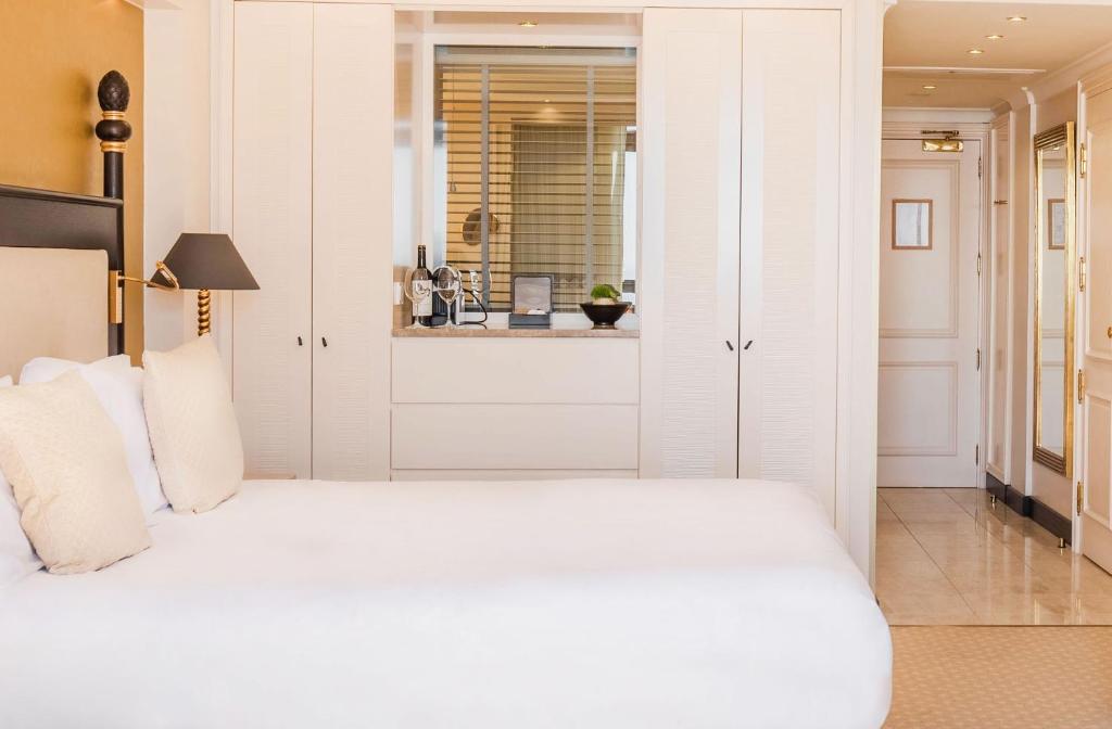 Mūsdienīgs viesnīcas numurs ar ērtu gultu, baltu gultasveļu un stilīgu interjeru. Numurā ir arī viesu ērtībām paredzēta zona ar vīna pudelēm un spoguli.