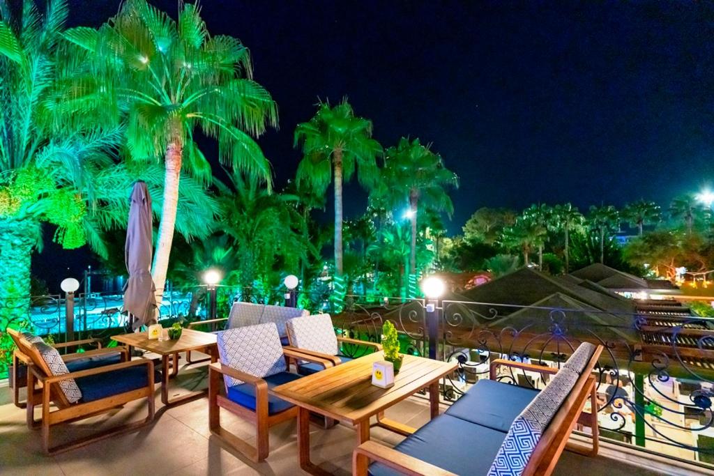 L'ancora Beach Hotel terase ar palmām naktī