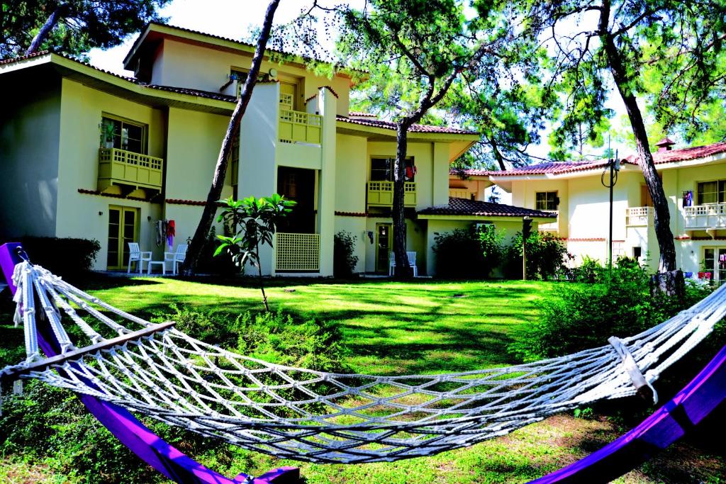 Hammocks in the garden at Ulusoy Kemer Holiday Club surrounded by nature.