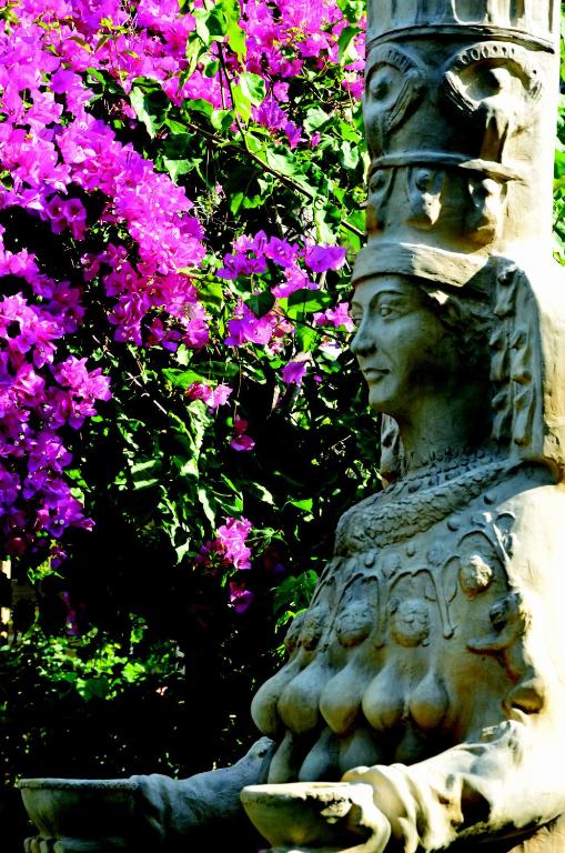 Sculpture surrounded by vibrant bougainvillea at Ulusoy Kemer Holiday Club.