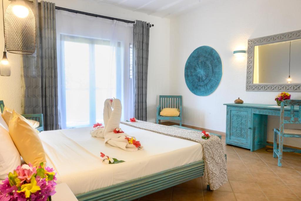 VOI Kiwengwa Beach suite with elegant decor and floral accents.