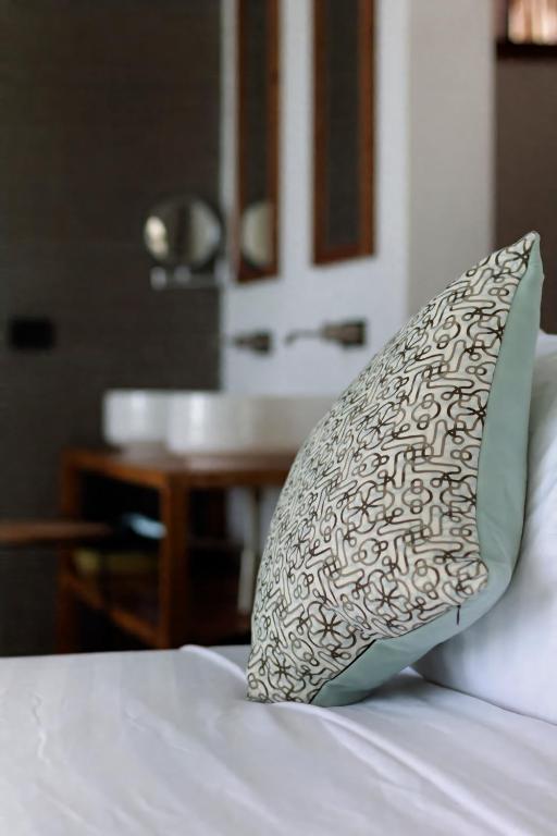 Karafuu Beach Resort & Spa viesnīcas numurs ar spilvenu un vannasistabu.