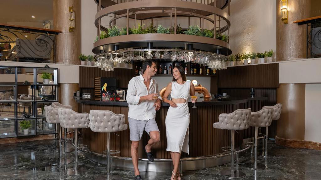 Jauns pāris izbauda dzērienus Numa Club Side bārā pie elegantā galda.