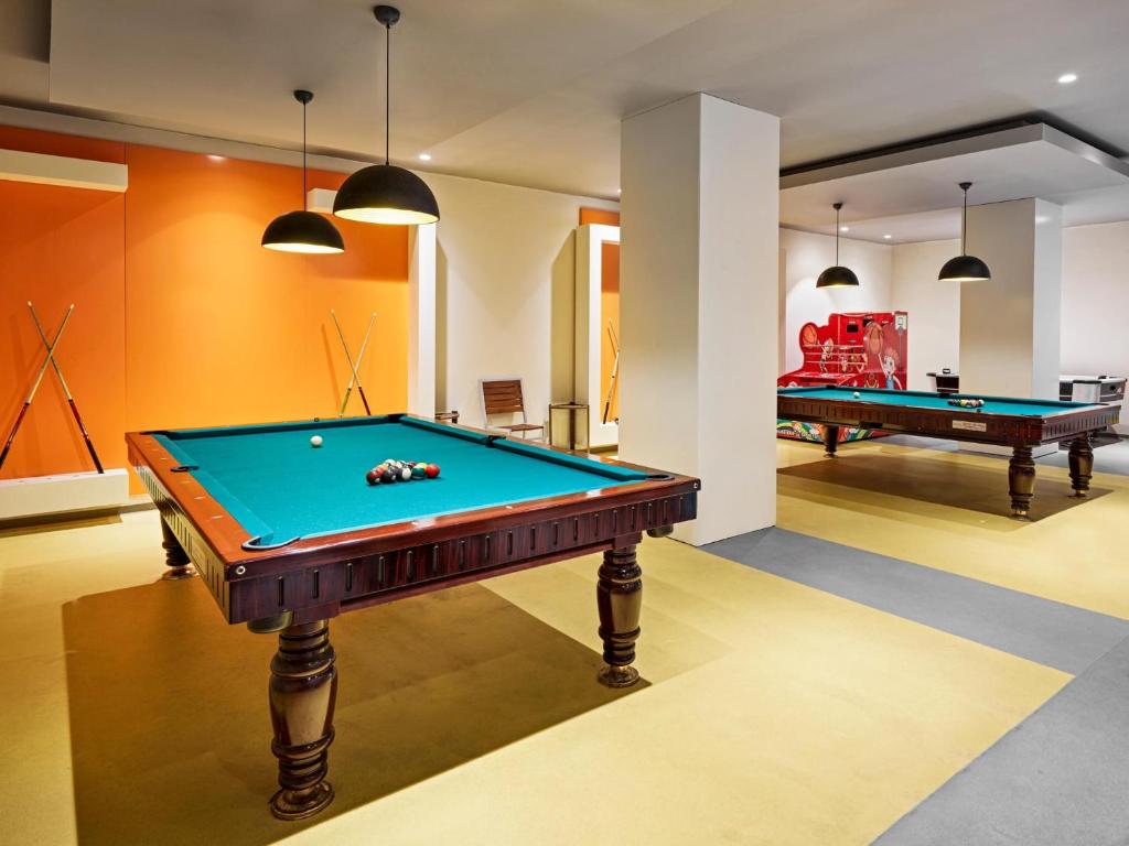Billiard room at Voyage Sorgun with two tables and vibrant decor.