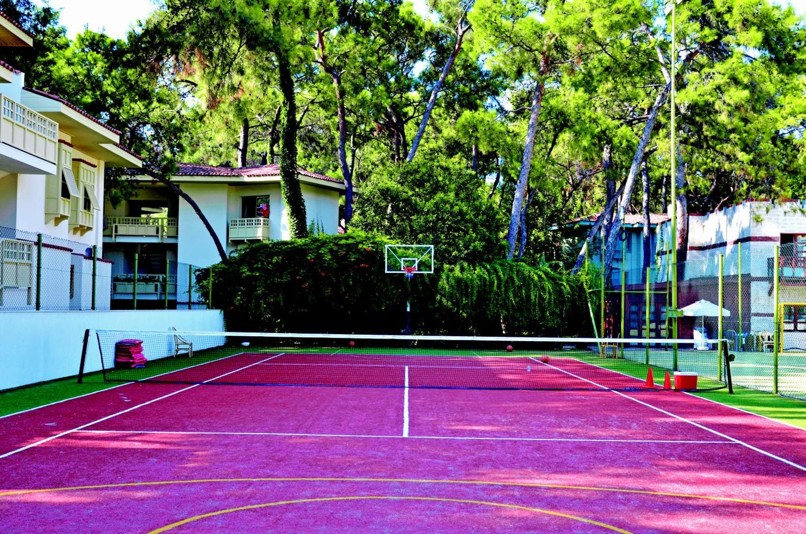 Ulusoy Kemer Holiday Club tenisa korts un basketbola grozs priežu meža ieskautā teritorijā Kemeras reģionā, Turcijā