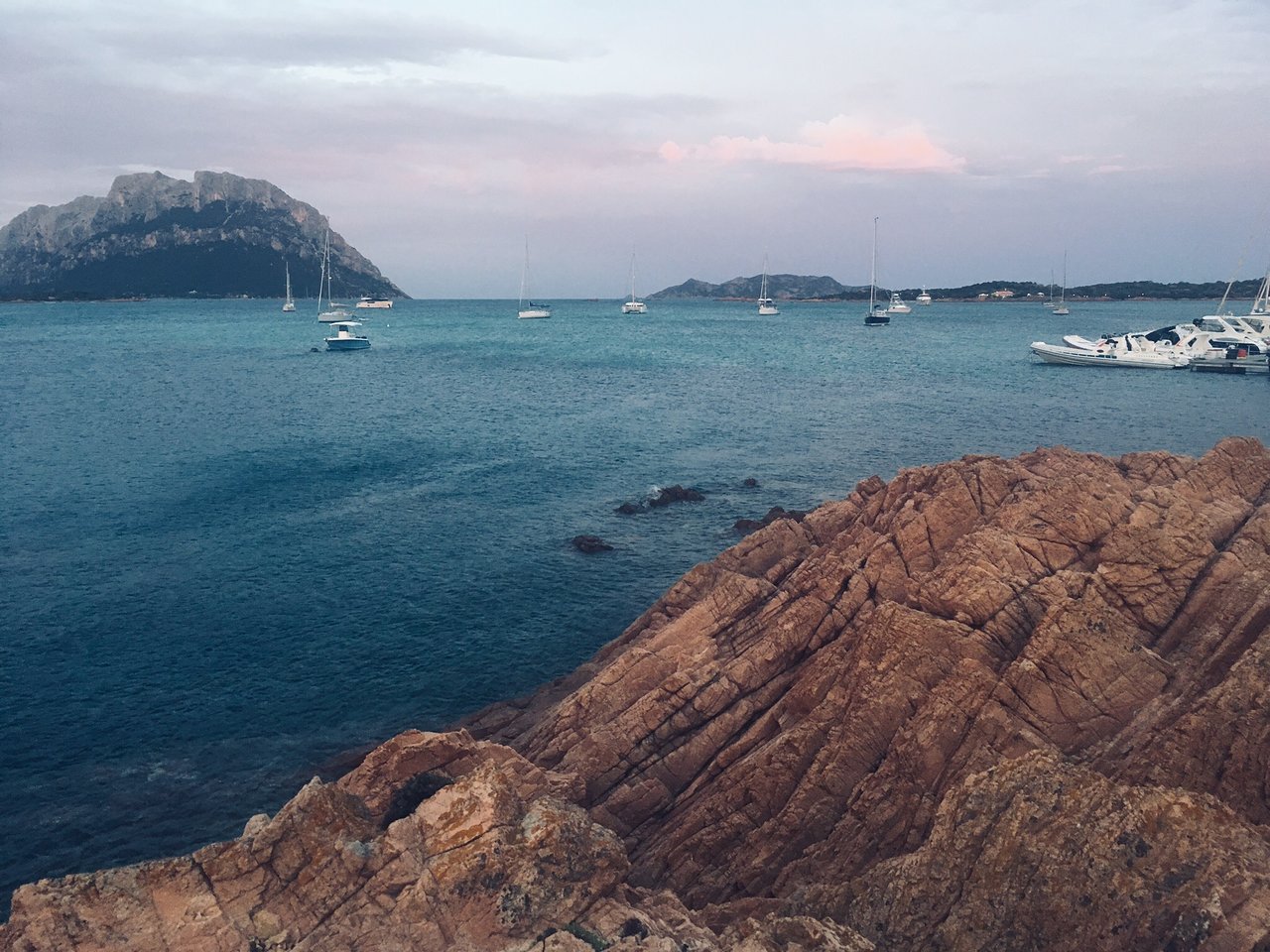 Krasta ainava ar jahtām un kalniem pie San Paolo.