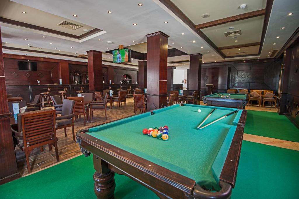 Billiards area at SUNRISE Royal Makadi Resort with green felt tables.