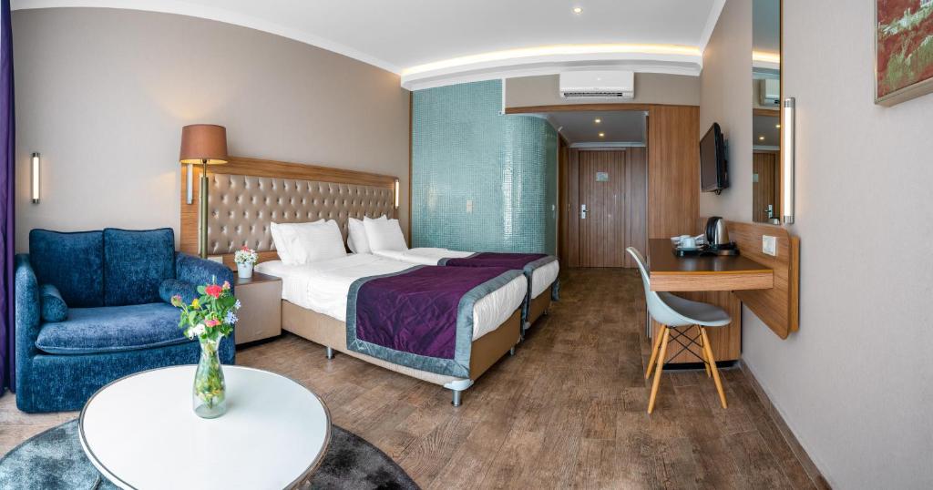 Michell Hotel & Spa numurs ar divām gultām un atpūtas zonu.