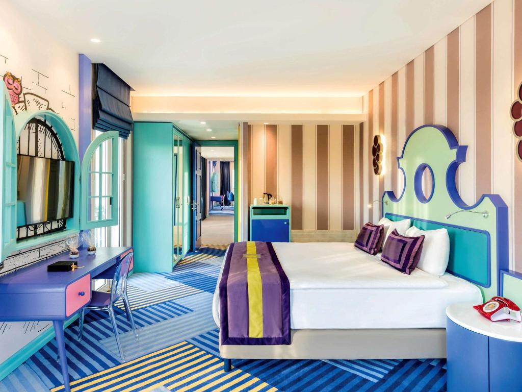 Krāsains numurs viesnīcā The Land of Legends Kingdom Hotel ar modernas iekārtojuma detaļām.