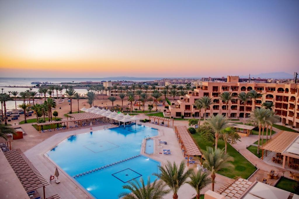 Continental Hotel Hurghada baseins ar palmām un jūru fona