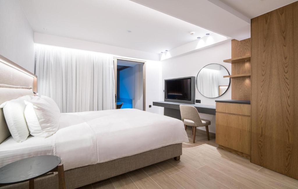 Mūsdienīgs numurs Akasha Beach Hotel & Spa ar baltām sienām un dabīgu gaismu.