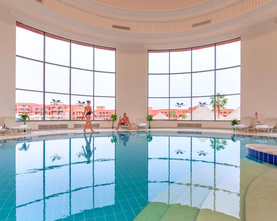 Iekštelpu baseins Pickalbatros Laguna Club Resort ar lieliem logiem un atpūtas zonu.