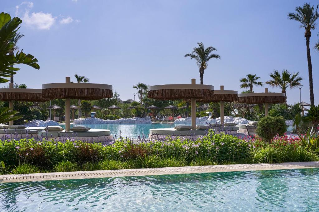 Atlantica Imperial Resort baseins ar saulessargiem un ziediem