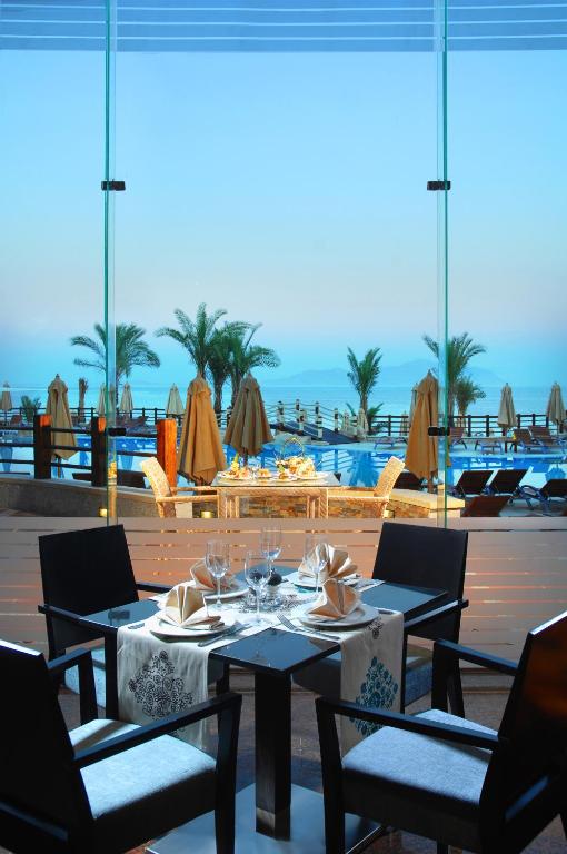 Elegant dining setup at Xperience Sea Breeze Resort with ocean view.