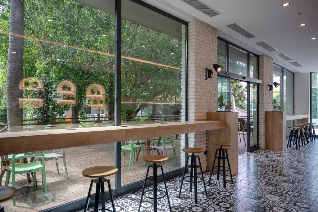 Skaista kafejnīca Sailor’s Beach Club ar lieliem logiem un terasi piekrastē.