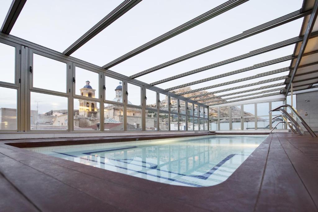 Apskatāma moderna iekštelpu peldbaseina ar stikla sienām, kas piedāvā skatu uz kalniem un vecām ēkām. Peldbaseins ir ierīkots koka grīdā un apgaismots ar dabiskiem gaismas avotiem.