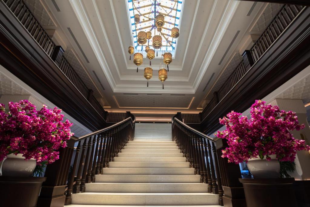 Elegant stairway with floral arrangements at Swandor Hotels & Resorts Topkapi Palace.