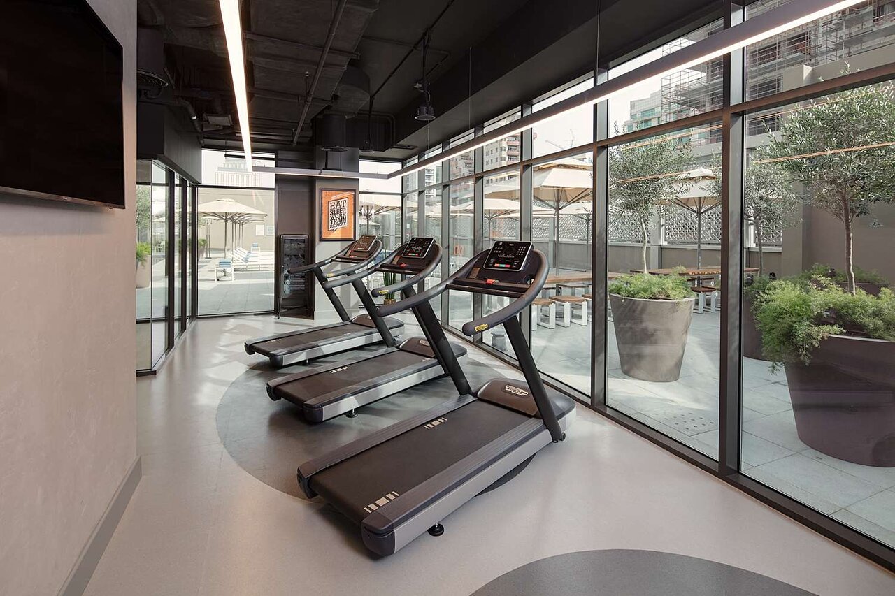 Rove Dubai Marina modern fitness center with treadmills.