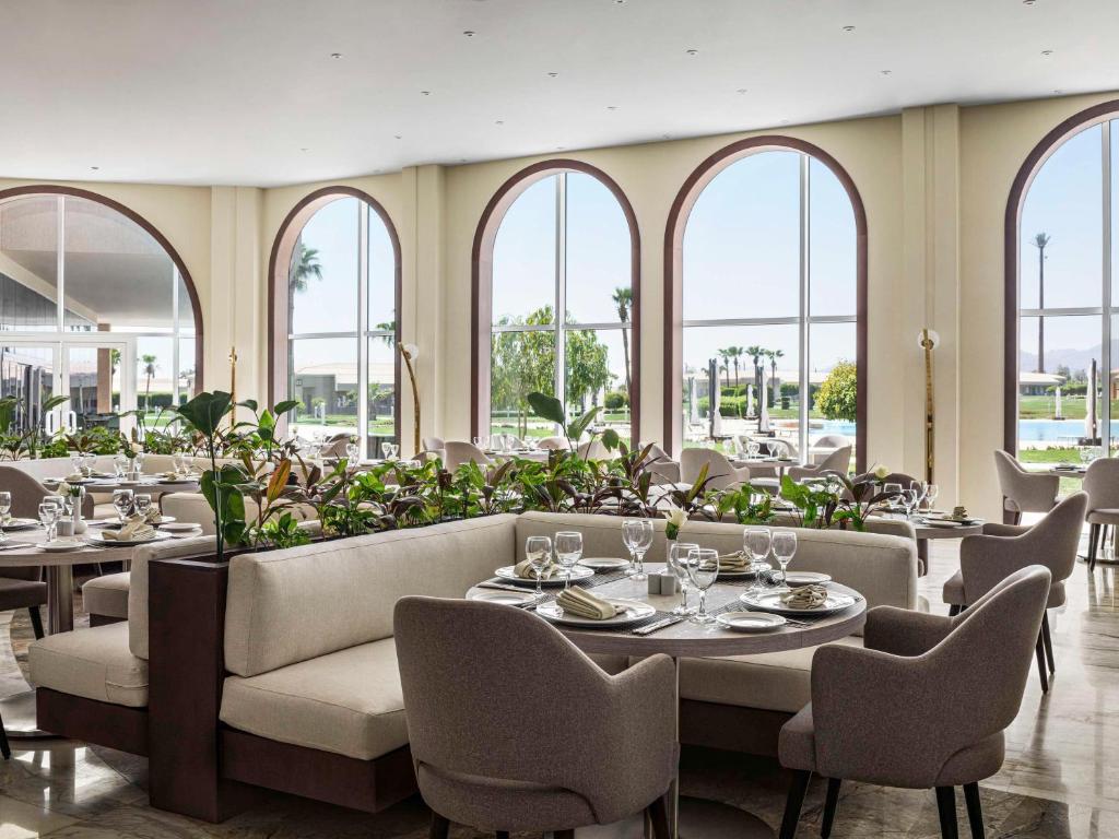 Eleganti iekārtots restorāns viesnīcā Pickalbatros Golf Luxury Suites ar skatu uz dārzu.