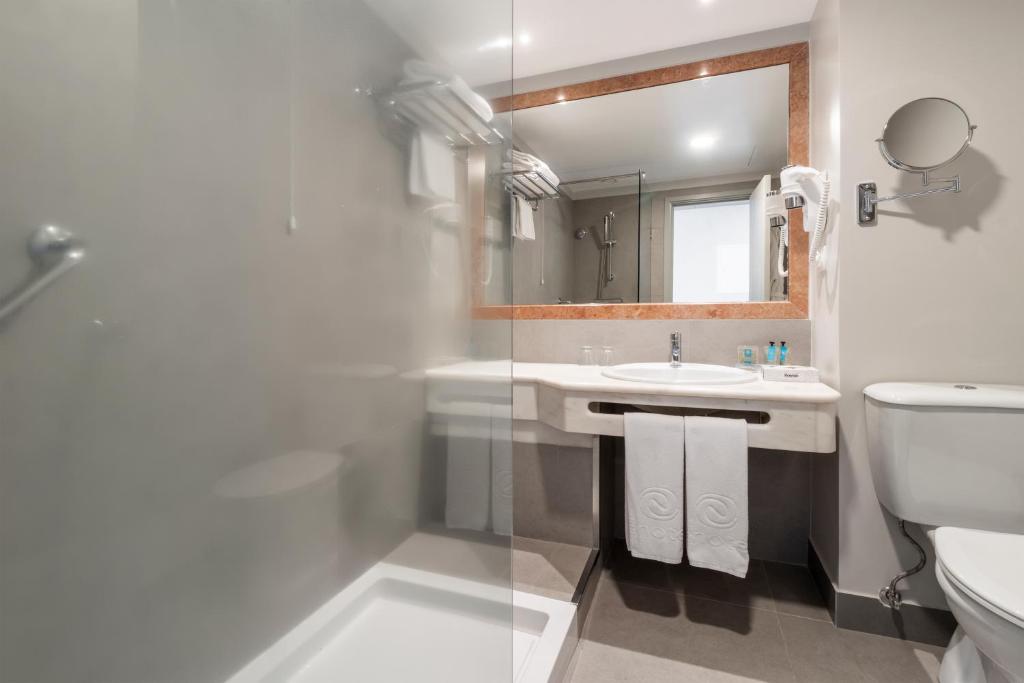 Mūsdienīga vannas istaba ar dušas kabīni, izsmalcinātu spoguli un elegantu izskatu. Telpa ir labi apgaismota un aprīkota ar visām nepieciešamajām ērtībām.