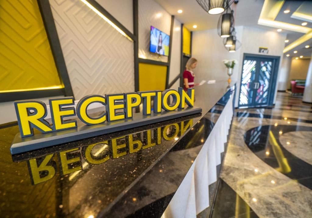 CAMPUS HILL HOTEL reģistratūra ar modernu interjeru un laipnu apkalpošanu.