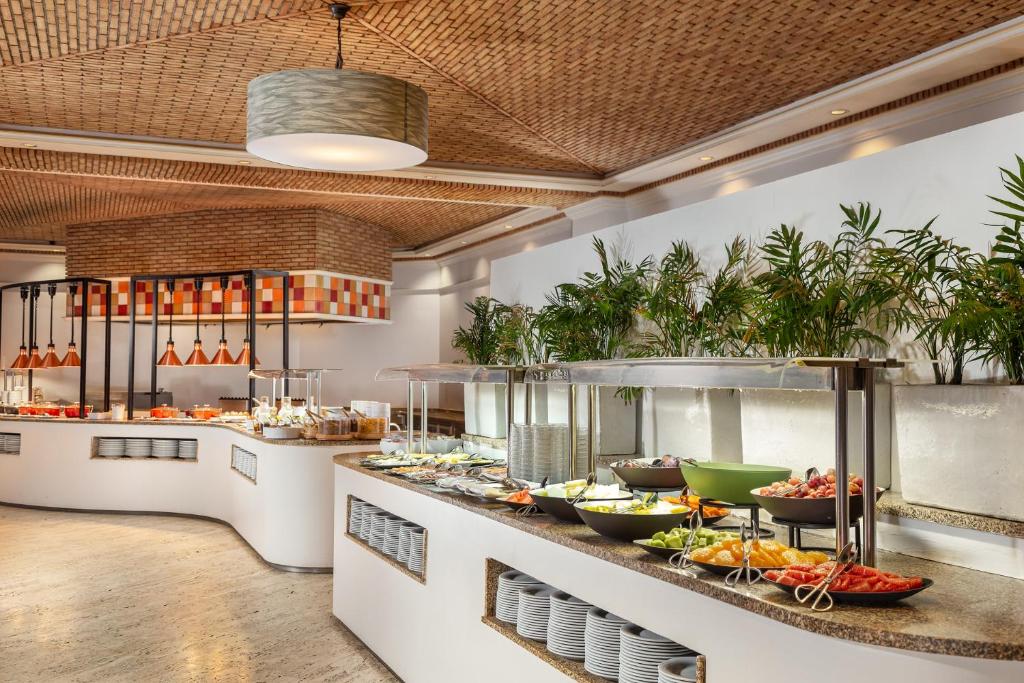 Buffet with fresh fruits and dishes at Grande Real Santa Eulalia Resort & Hotel Spa