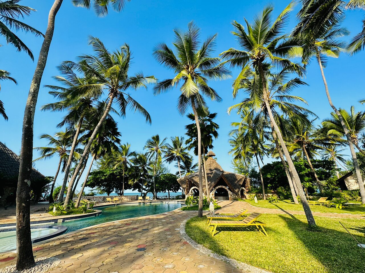 Palumbo Mnemba tropiska oāze ar baseinu un palmām.