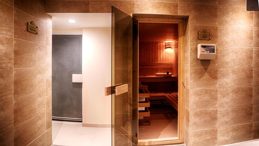 Rose Park Hotel Al Barsha sauna entrance with warm lighting.