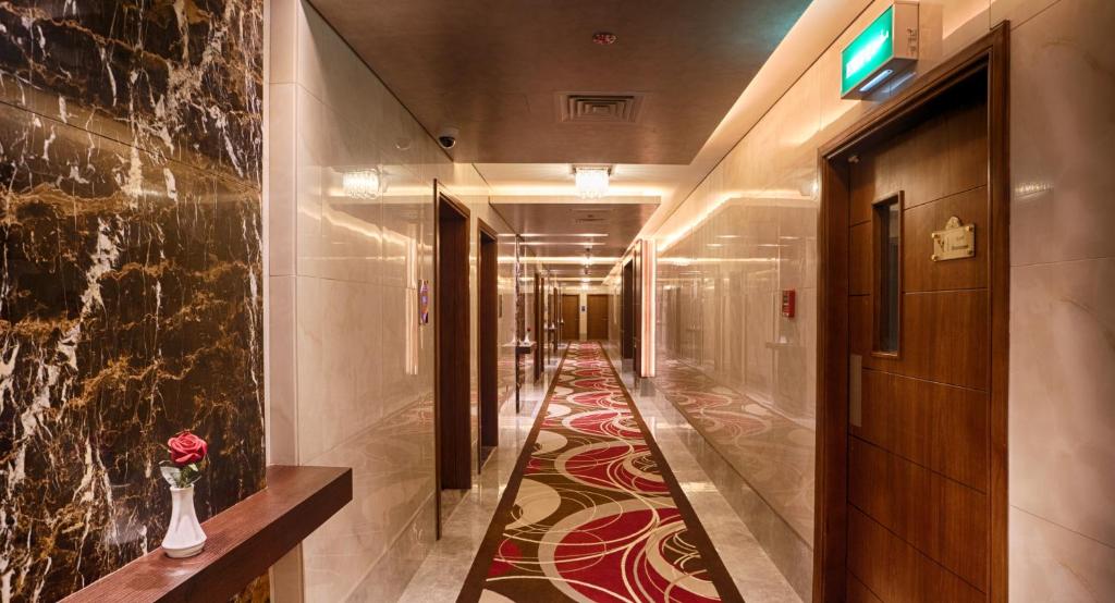 Rose Park Hotel Al Barsha elegant hallway with modern decor.