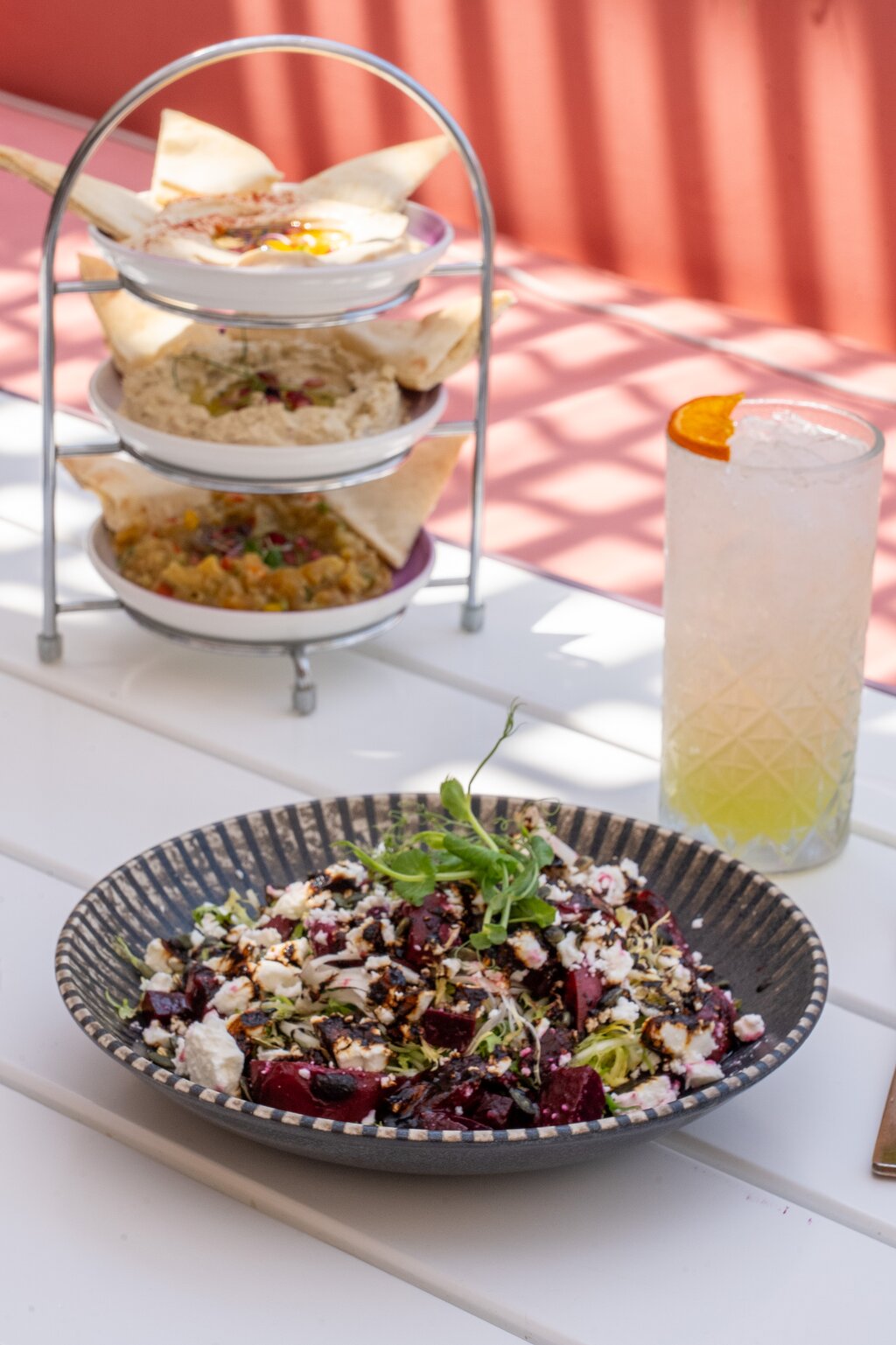 Andaz Dubai The Palm, elegant Mediterranean dish with fresh salad and dips.