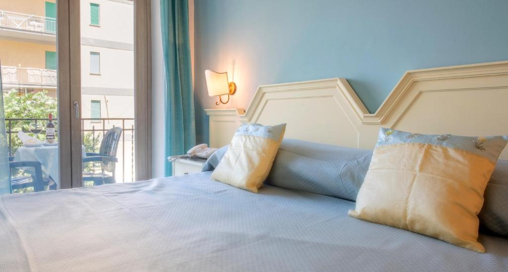 Gaiša guļamistaba ar zilu sienu, ērtu gultu un spilveniem, kā arī balkonu, no kura paveras skats uz dārzu. Ideāla vieta relaksācijai un atpūtai.