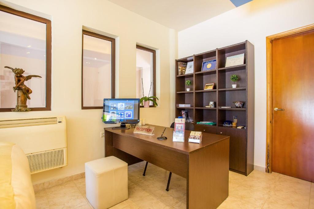 Reģistratūra ar modernu darba galdu, datoru un plauktu grāmatām, dekoratīviem elementiem un gaisa kondicionieri. Telpa ir gaiša un mājīga, radot patīkamu atmosfēru.