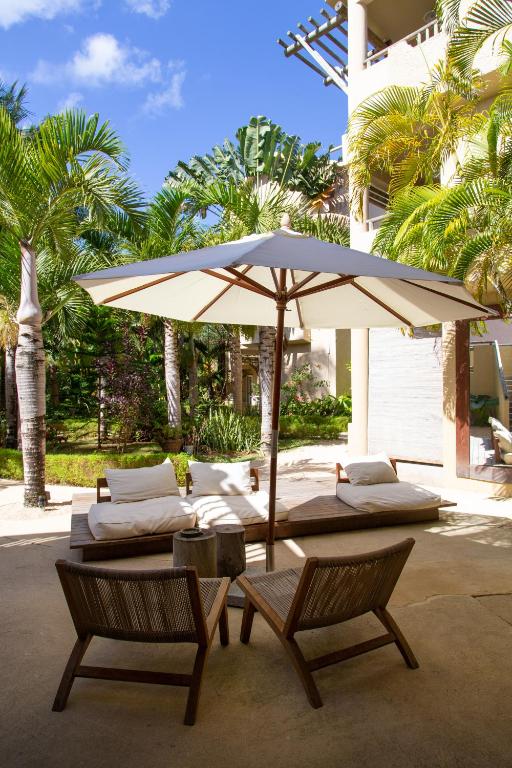 Miers un relaksācija ainavā ar palmu kokiem un sauļoties domātu terasi ar saules umbrellu. Ideāla vieta atpūtai brīvā dabā.